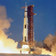 A rocket carrying Apollo 11 and its crew toward the Moon lifts off